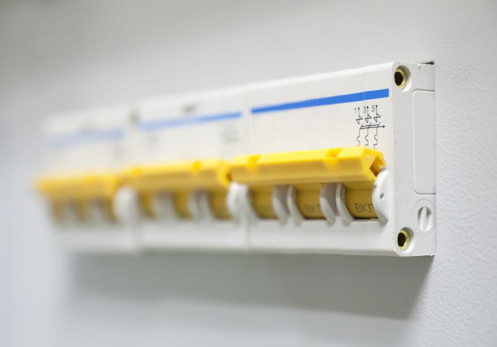 A row of white miniature circuit breakers