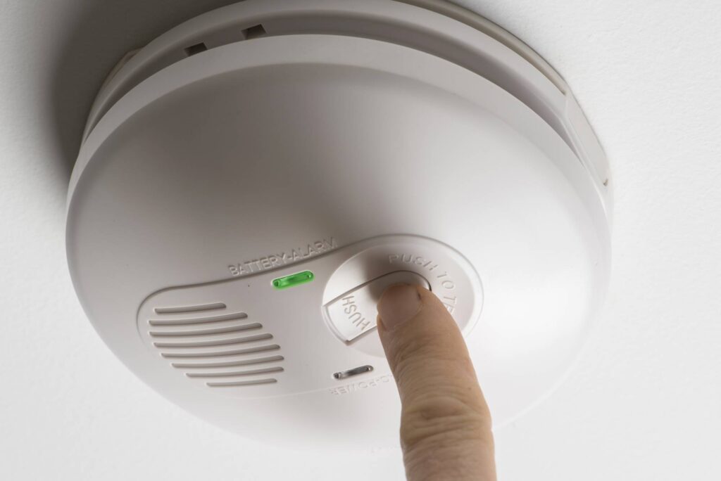 testing a home smoke alarm