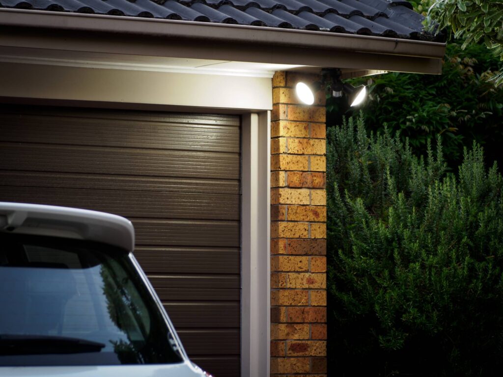 view of garage door with security lights