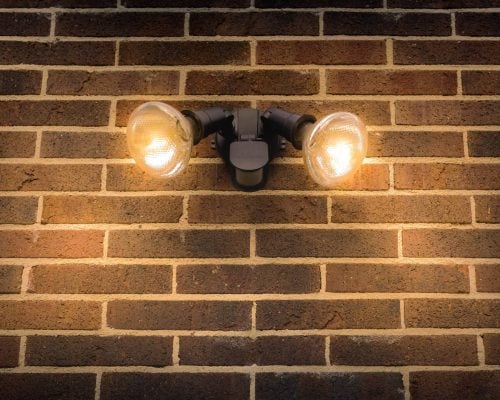 flood light on external brick wall daytime look up