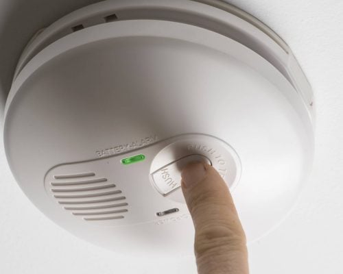 testing a home smoke alarm